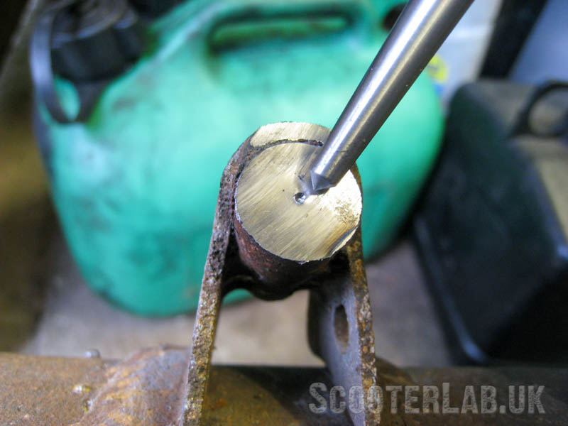 Use a centre-punch to mark the exact centre of the pin before drilling.