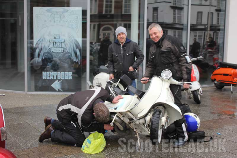 It's always best to have friends to take the piss whilst you mend a scooter in the rain.