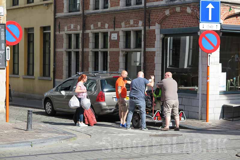Lars (centre) loads Tez's scooter up on the trailer