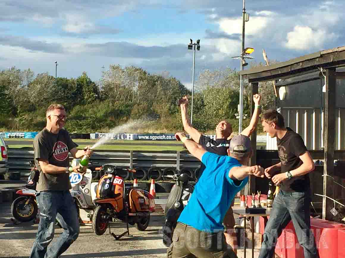 Team SLUK celebrate with a bottle of pomagne - photo courtesy of race groupie, Jenny Gordon