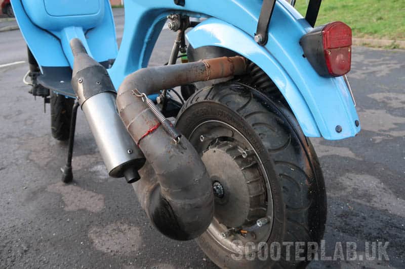 The exhaust hangs out the side quite a way, but aesthetically it balances the offset Vespa engine