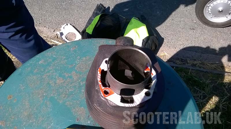 New base gasket made from the box of the gasket sealer. The bin made a handy roadside workbench
