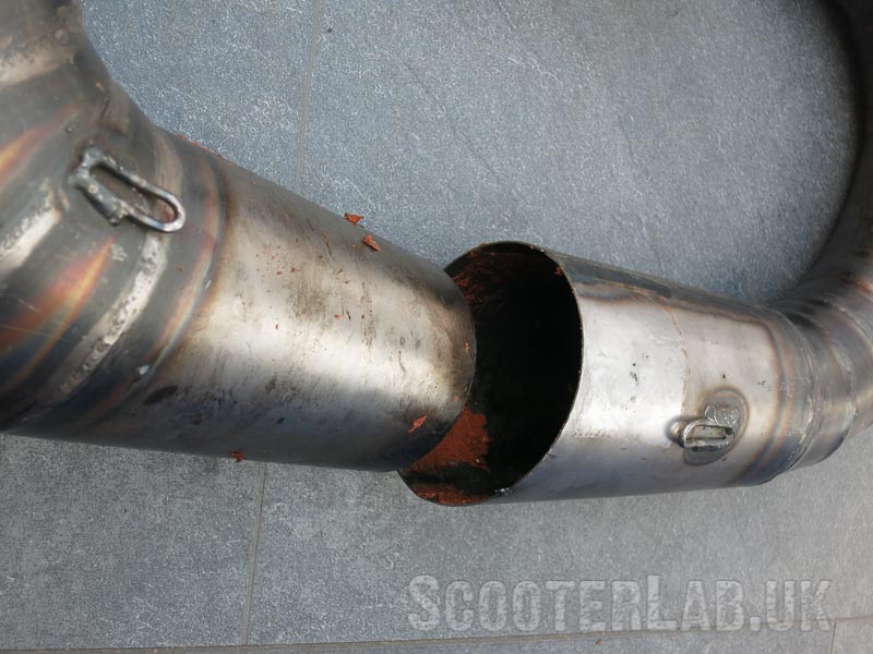 Twin coned downpipe to chamber fit is unusual. High-temperature silicone was used to seal the joint