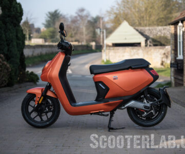 the NIU MQI GT Evo electric scooter side on in orange